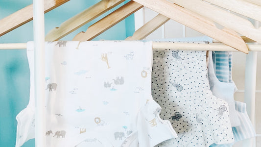 Assorted secondhand baby onesies from a Vancouver children's consignment shop