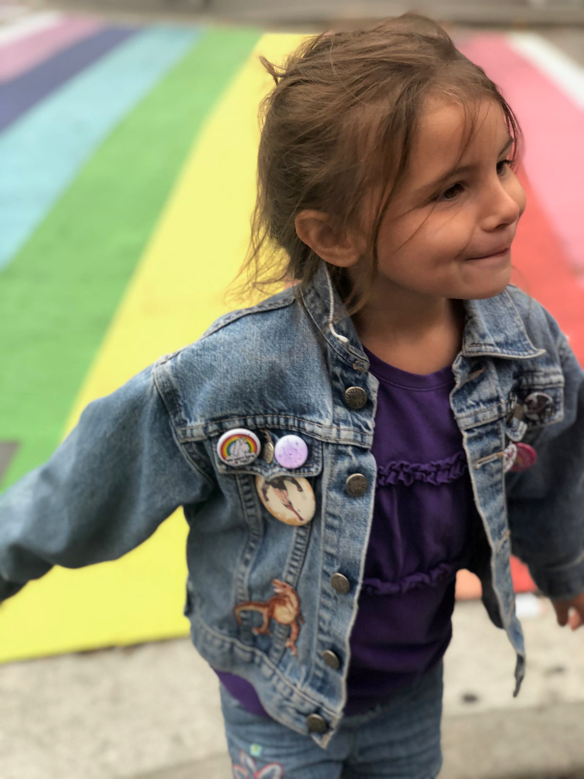 Child in a pre-loved denim jacket