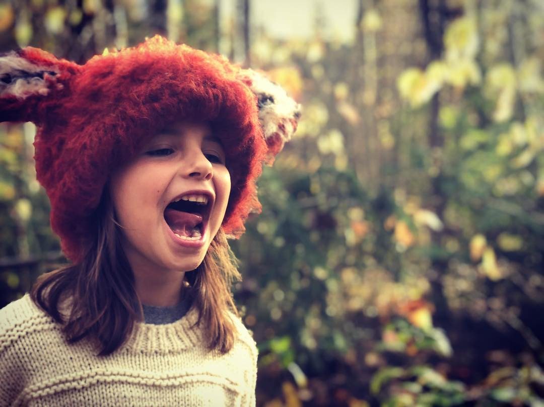 Girl in a fox-fur hat laughing